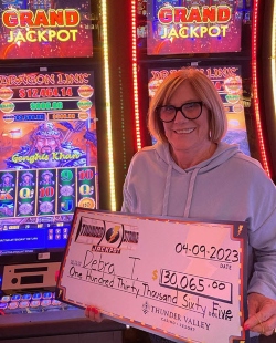 Debra Taylor poses with her $130,064.45 jackpot check. (Photo courtesy of Thunder Valley Casino.)